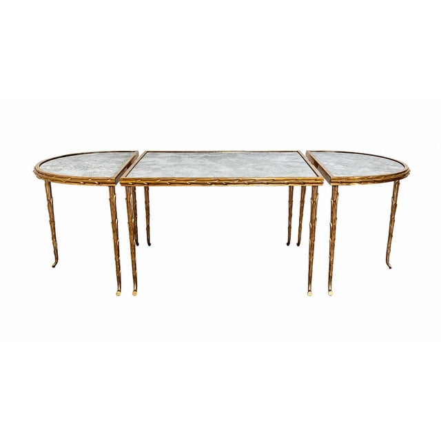 Maison Baguès Bronze Doré Palmier Tripartite Coffee Table with Églomisé Mirrored Glass France, Circa 1950 There is an...