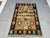 This Afghan Chobi flatweave kilim features a colorful tribal geometric design with horizontal bands and repeating diamond...