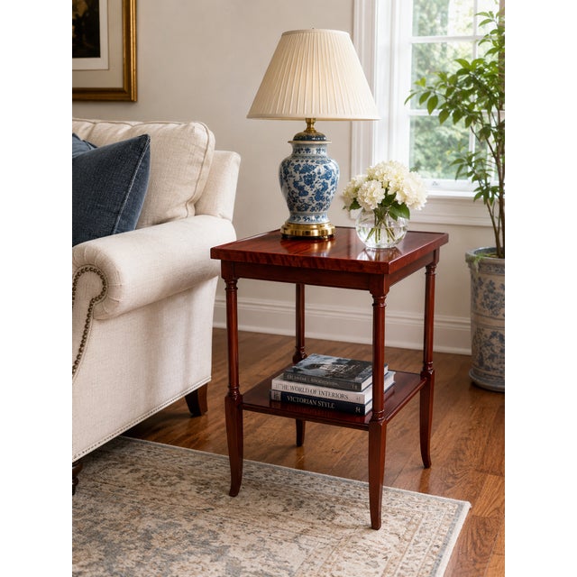 An elegant vintage two-tier side table featuring a rich mahogany-toned wood finish and beautifully compact proportions....