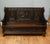 Impressive antique carved oak hall settle in the Renaissance Revival style featuring richly carved panels and bold...