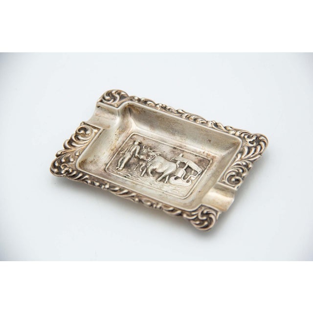Silver Ashtray with Cigarette Holders and Bucolic Scenes Reliefs, in Very Good conditions. Designed 1920 to 1949 This...