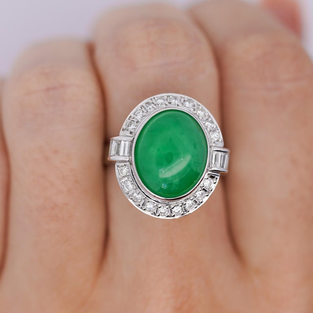 8.55 Carat Oval Cut Untreated Grade A "Fei Cui" Jadeite Jade with Diamonds in Platinum 900 Bezel set Ring. Details: Item...