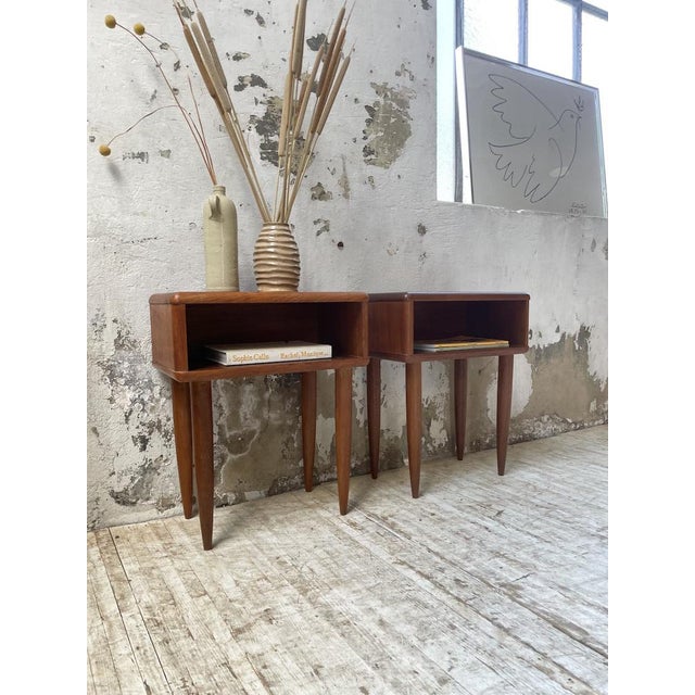 Old pair of bedside tables in teak and teak veneer of scandinavian origin. we love the open box with its beautiful curved...