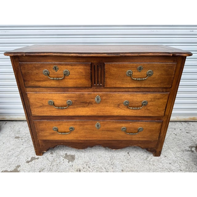 This vintage Hekman chest of drawers showcases classic craftsmanship and timeless design, featuring a warm, rich wood...