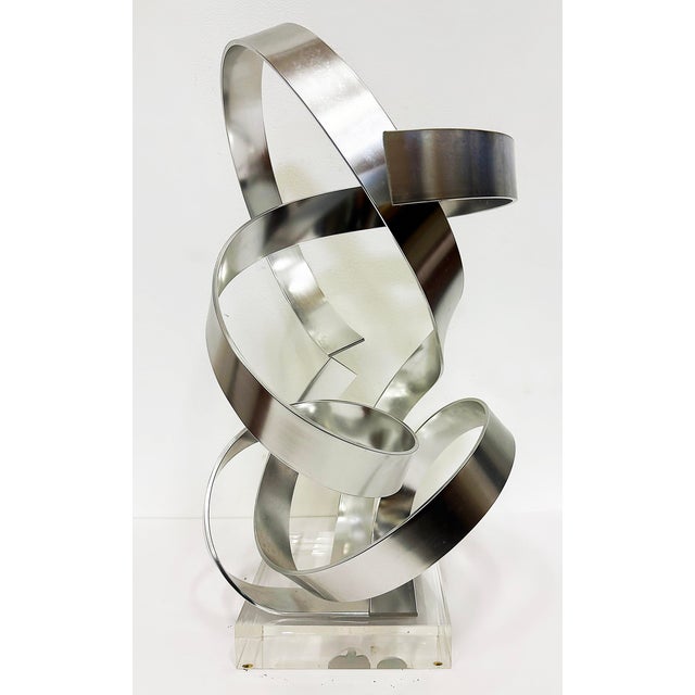 Dan Murphy 1985 Abstract Ribbon Sculpture on a Lucite Base Offered for sale is an unusually intricate abstract Ribbon...