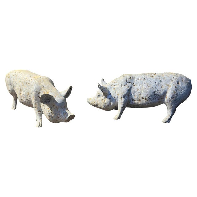 A pair of cast iron pigs painted white lightly distressed from weather. Great size and form. Very well cast. Ideal garden...