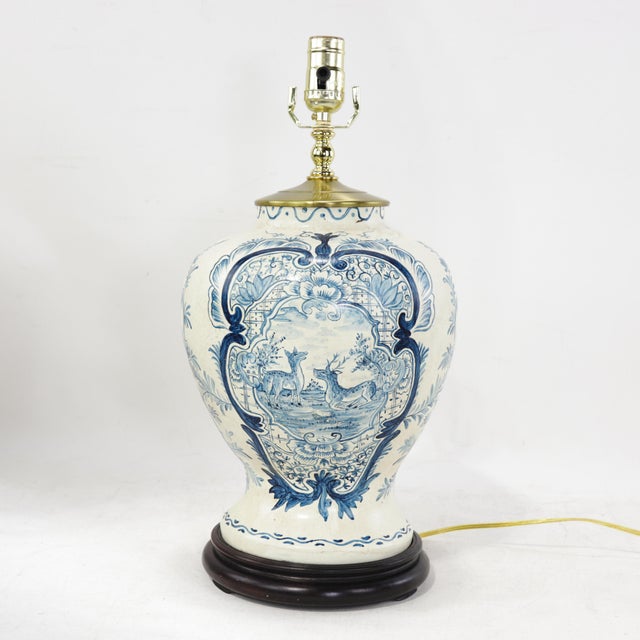 This pair of vintage table lamps features a classic ceramic vase silhouette finished in a warm antiqued cream glaze. The...