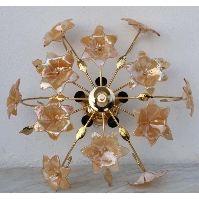 Vintage Murano glass chandelier full of orange iridescente flowers. The chandelier has 5 light points with E14 connection,...