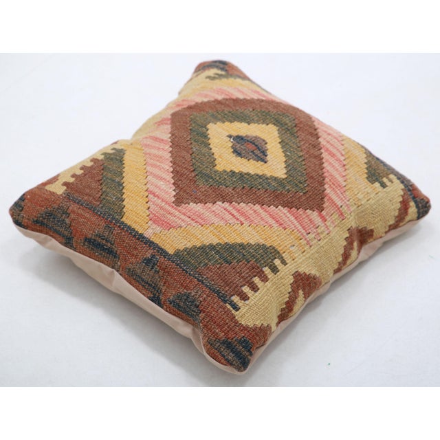 A one-of-a-kind handwoven Afghan wool kilim accent pillow featuring concentric diamond medallion. Cut and sewn by hand...