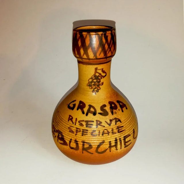 This vase bears the markings IP Bucci, 1972-73, as well as Graspa special reserve Marquis Burchiellaro.