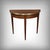 This mahogany half-moon games table, crafted in the refined Louis XVI style at the beginning of the 20th century,...