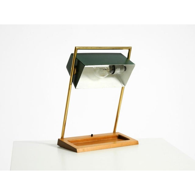 Rare, large, original 1960s table lamp featuring a brass frame and a teak base. manufacturer is temde. Made in...