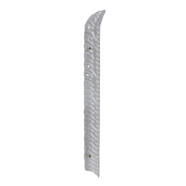Elegant pair of wall sconces handcrafted in Italy, featuring elongated feather-shaped shades made of hand-blown Murano...