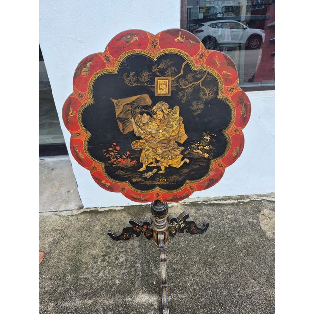 Antique Japanes table hand decorated with figures in the traditional style on an ebonized background with birds and flowers.