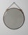 A circa 1920 French wall mirror featuring a bronze frame designed in the Art Deco style, with a focus on symmetry and...