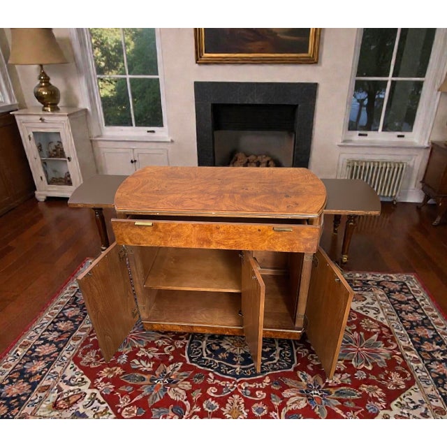 This American of Martinsville expandable cabinet dates to the 1940s–1950s and features a striking burl veneer top with...