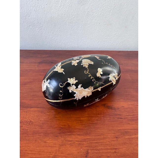 Striking Japanese hand-carved melon-form lacquer box, finished in glossy black lacquer and delicately decorated with...