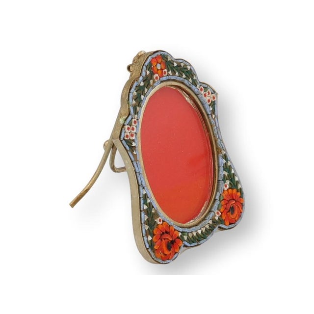 Italian micromosaic picture frame with arched silhouette, decorated with floral glass tesserae surrounding a red glass...