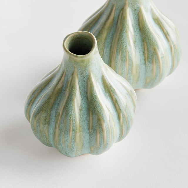 With a sculpted body and thicklyapplied reactive glaze, this natureinspired set of bud vases is a work of art. The...