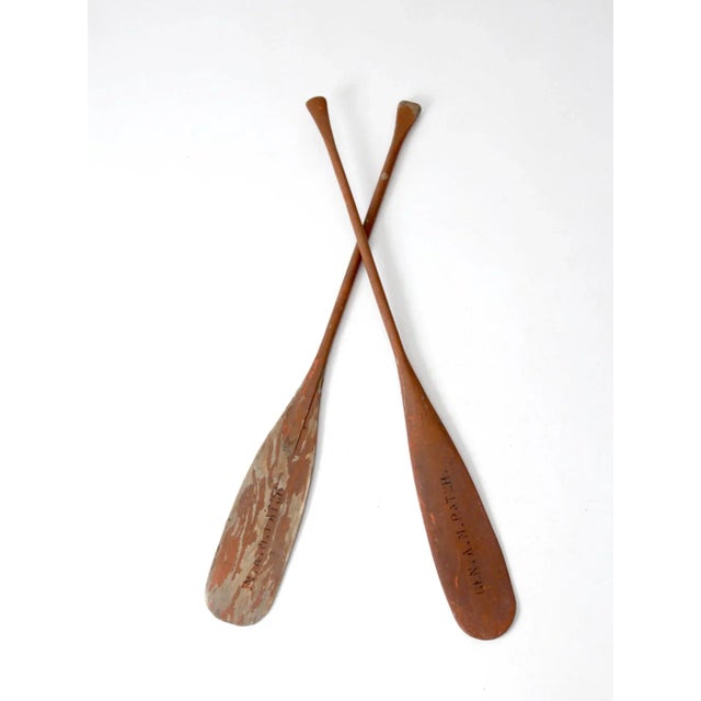 Add rustic charm to your home or coastal decor with this pair of mismatched US Navy oars. Originally from the USNS General...