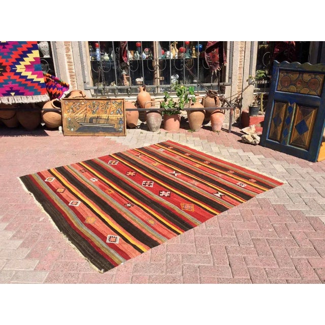 This beautiful, vintage, handwoven kilim is approximately 60 years old. It is handmade, of very fine quality hand spun...