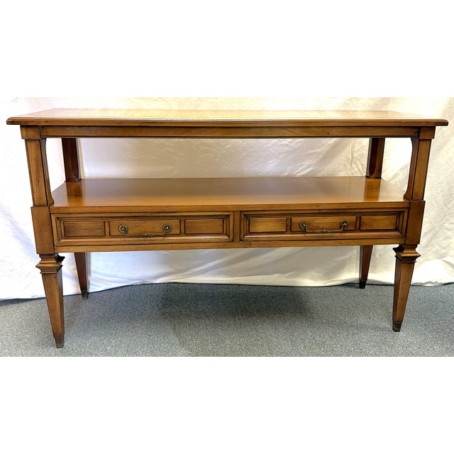 Timeless vintage Hekman Furniture console table from the 1970's. It is made of solid wood in a medium tone finish with a...