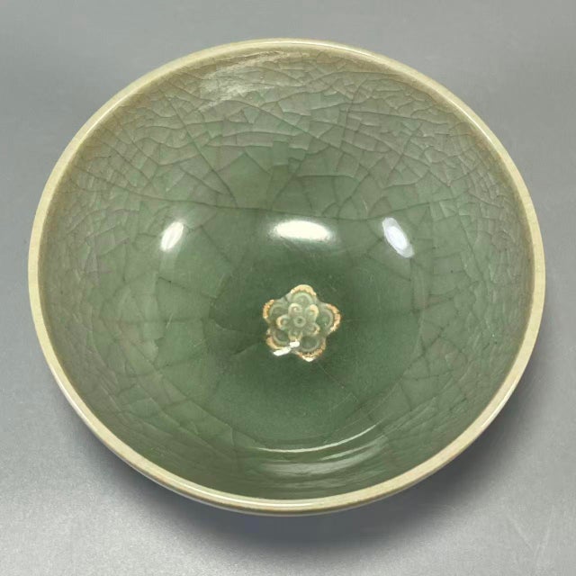 This is a classical Chinese Longquan celadon porcelain bowl. Features beautiful crackled glaze, delicate flower relief...