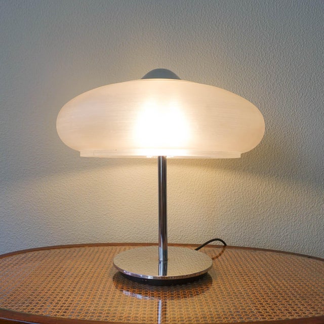This table lamp was designed and produced in Germany, during the 1970s.The base is made of chrome metal where an brushed...