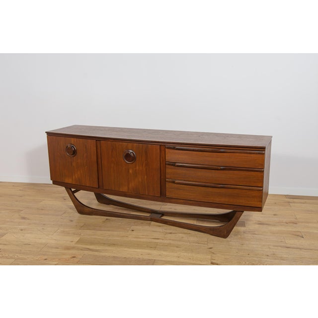 This sideboard was manufactured by the British furniture maker Beautility during the 1960s. The piece is distinguished by...