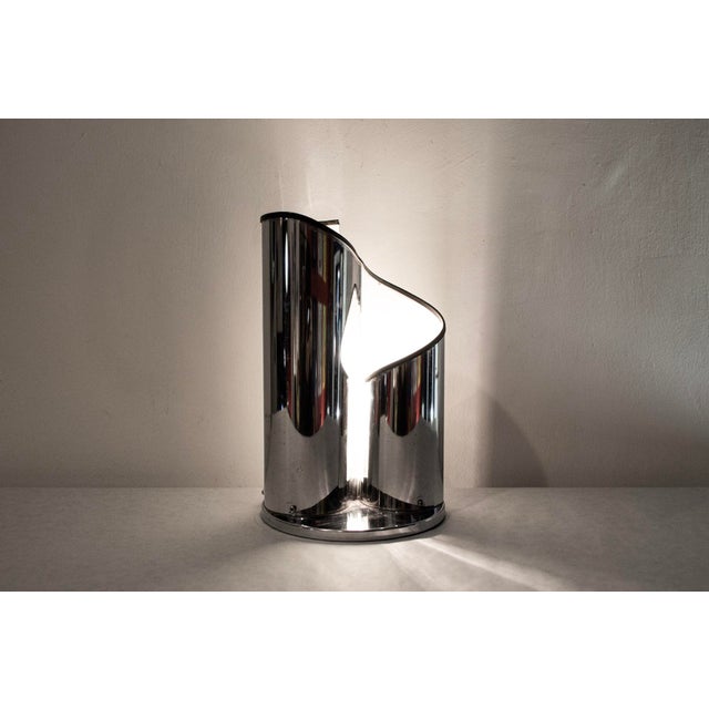 Chromed metal table lamp with rubber detail. Made in Italy 1970s European Plug (up to 250V).The wiring of this item may be...