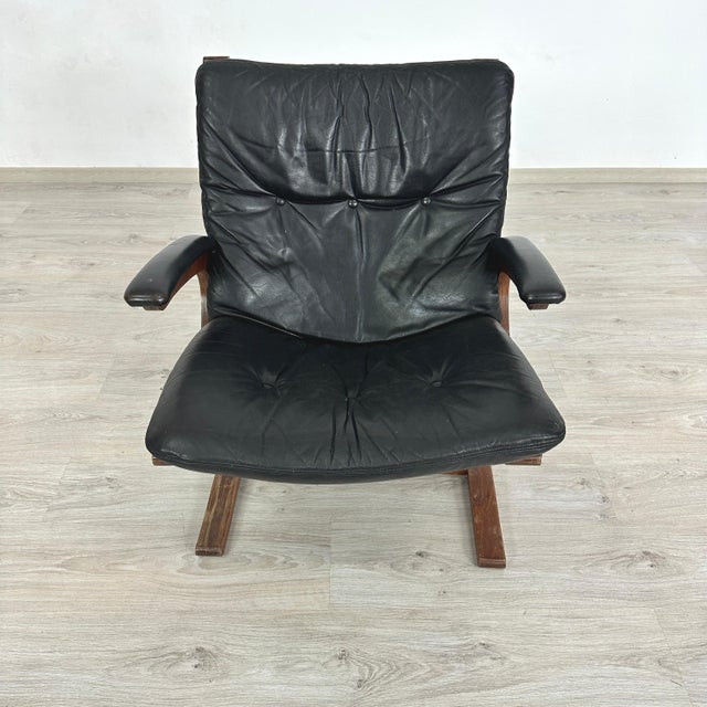 Dimensions: H 30” x W 27.5” x SD 19.5” x SH 16.5 Vintage Kengu-Armchair in black leather and bentwood, designed by Elsa &...