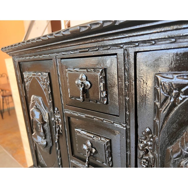 This Bargueno is embellished with a carving of Don Quixote de la Mancha bordered with branches of leaves. The desk is...