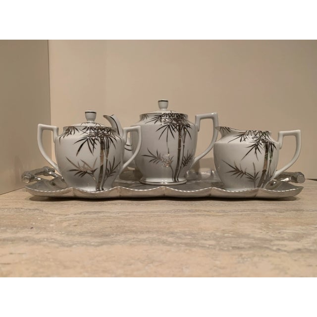 Vintage 4-Piece hand painted porcelain Asian Tea Set with silver palm tree motif. Included hammered meta tray with rose...