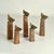 Group of five abstract sculptures in different heights are like a family of figures. They are hand made in copper and...