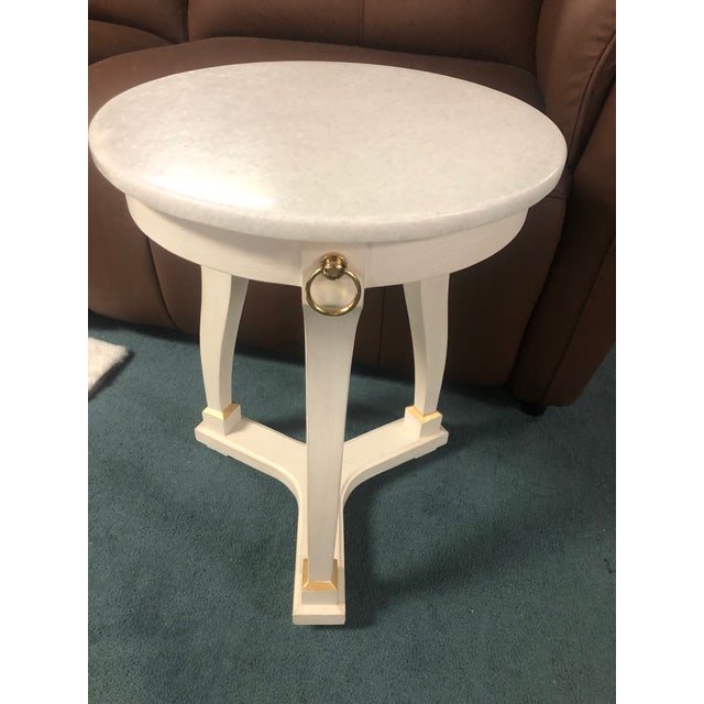 The Covington Drinks Table by Modern History Home is a handcrafted accent piece featuring a polished white slat marble...