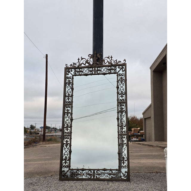 Beautiful ornate cast metal mirror with a Spanish Mediterranean feel to it. This is not antique and probably twenty or...