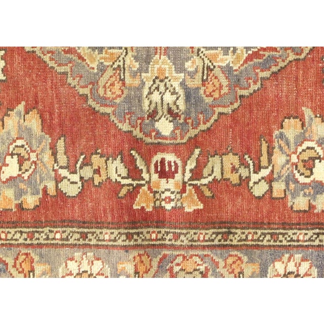Expertly handwoven in the Oushak region of Western Turkey, this Vintage Turkish Oushak Rug features a traditional design...