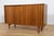 This is a small walnut sideboard produced in the 1960s in Denmark. The sideboard opens with two sliding doors, in inside...