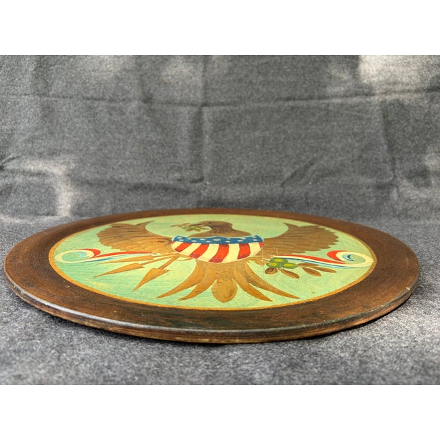 Vintage round hand painted , folk art, wood American eagle with shield and ribbons, wall decor., tray .Hook on the back...