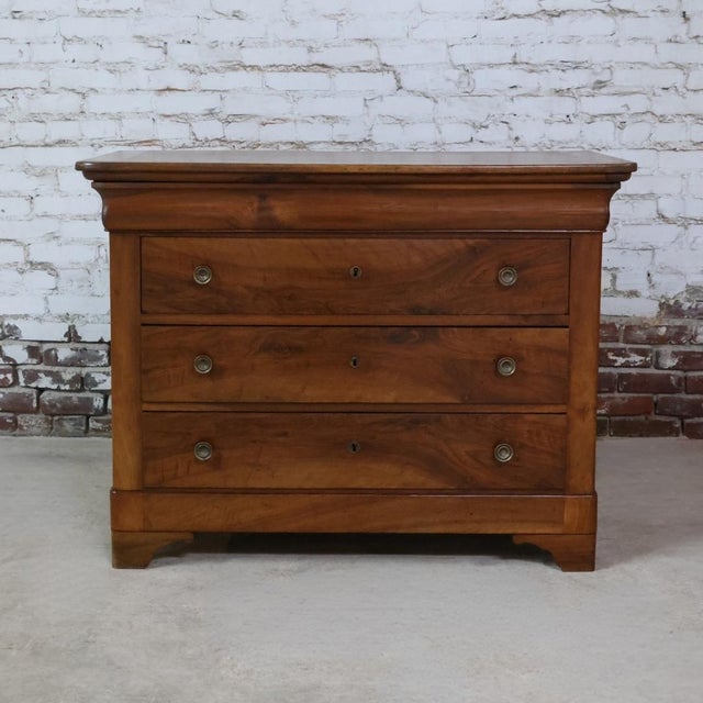 This 19th Century Louis Philippe solid walnut chest is a refined example of French antique craftsmanship, showcasing the...
