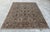 A hand-knotted area rug in the Sultanabad design, worked on a soft silver-grey ground with an allover garden pattern in...