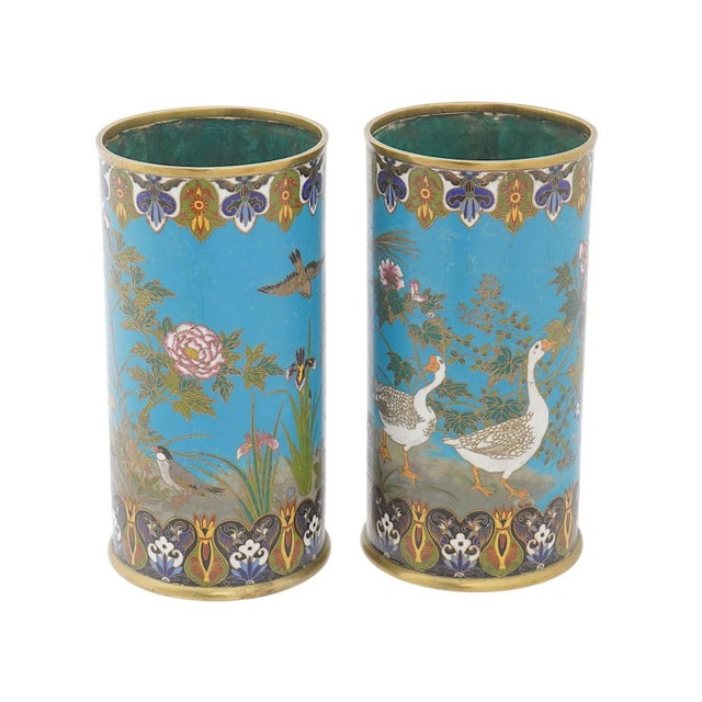A refined pair of Meiji period Japanese cloisonne enamel cylinders decorated with detailed scenes of birds among spring...