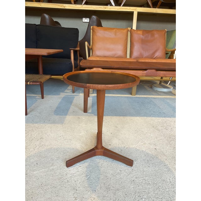 In good used condition, stable and sound in construction. Rich teak colour wood with an elegant black leather finish on...