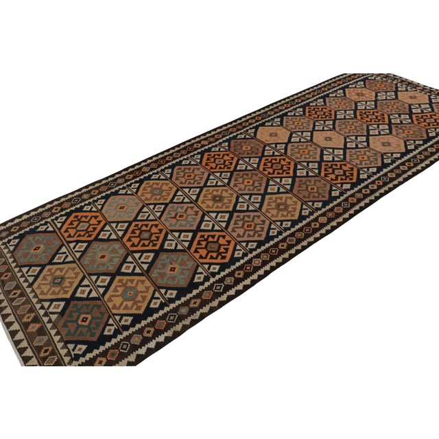 Hand-knotted in wool, circa 1960-1970, from the titular region of Turkey, this 5x14 vintage Afghan tribal kilim and...