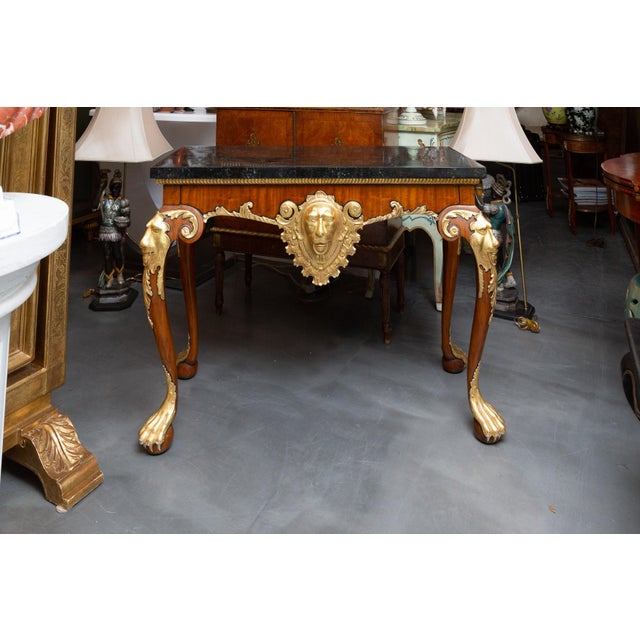 Handsomely designed yew wood Regency style console, the tessellated inlaid top with gilt beaded molding over a prominent...