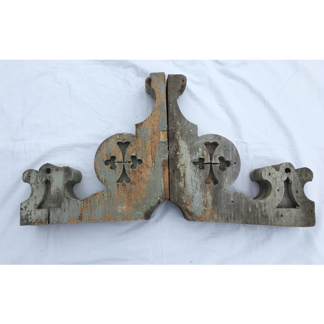 Pair of weathered wooden corbels. Wear consistent with age, chipped wood, paint loss.
