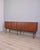 Teak wood sideboard with central drawers, a drop-leaf door on the left and two hinged doors on the right, both with locks,...