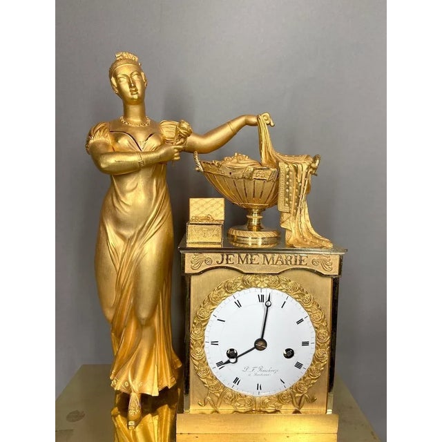 Indulge in the lavish splendor of the French Empire era with our magnificent 19th Century Gilt Bronze Table/Chimney Clock,...