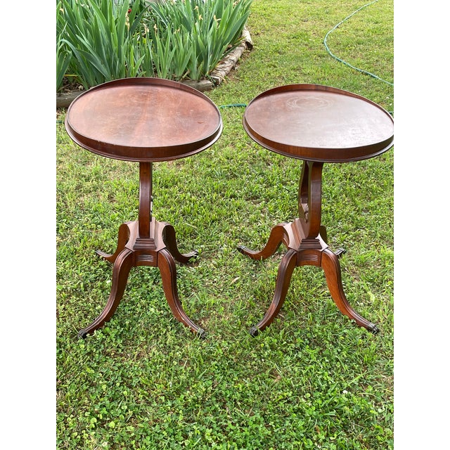 This beautiful pair of vintage, wooden tea tables feature oval shaped tops that have a gallery edge on each end. The feet...