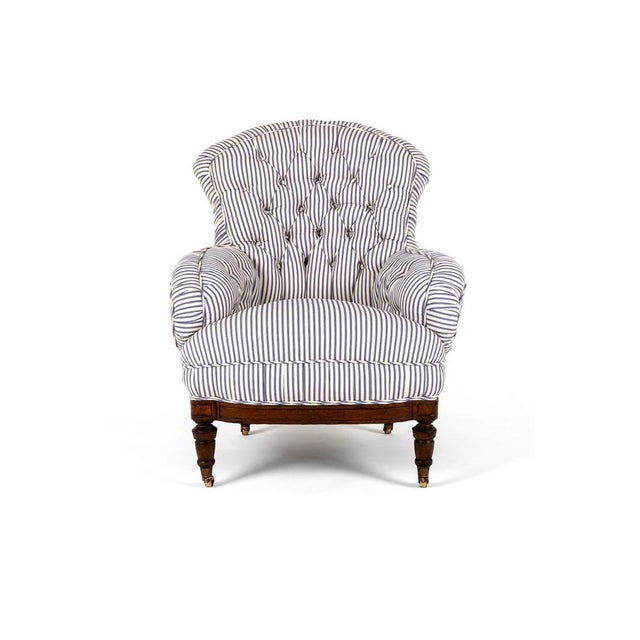 A wonderful victorian overstuffed button back armchair in blue stripe cotswold ticking. The armchair of generous...